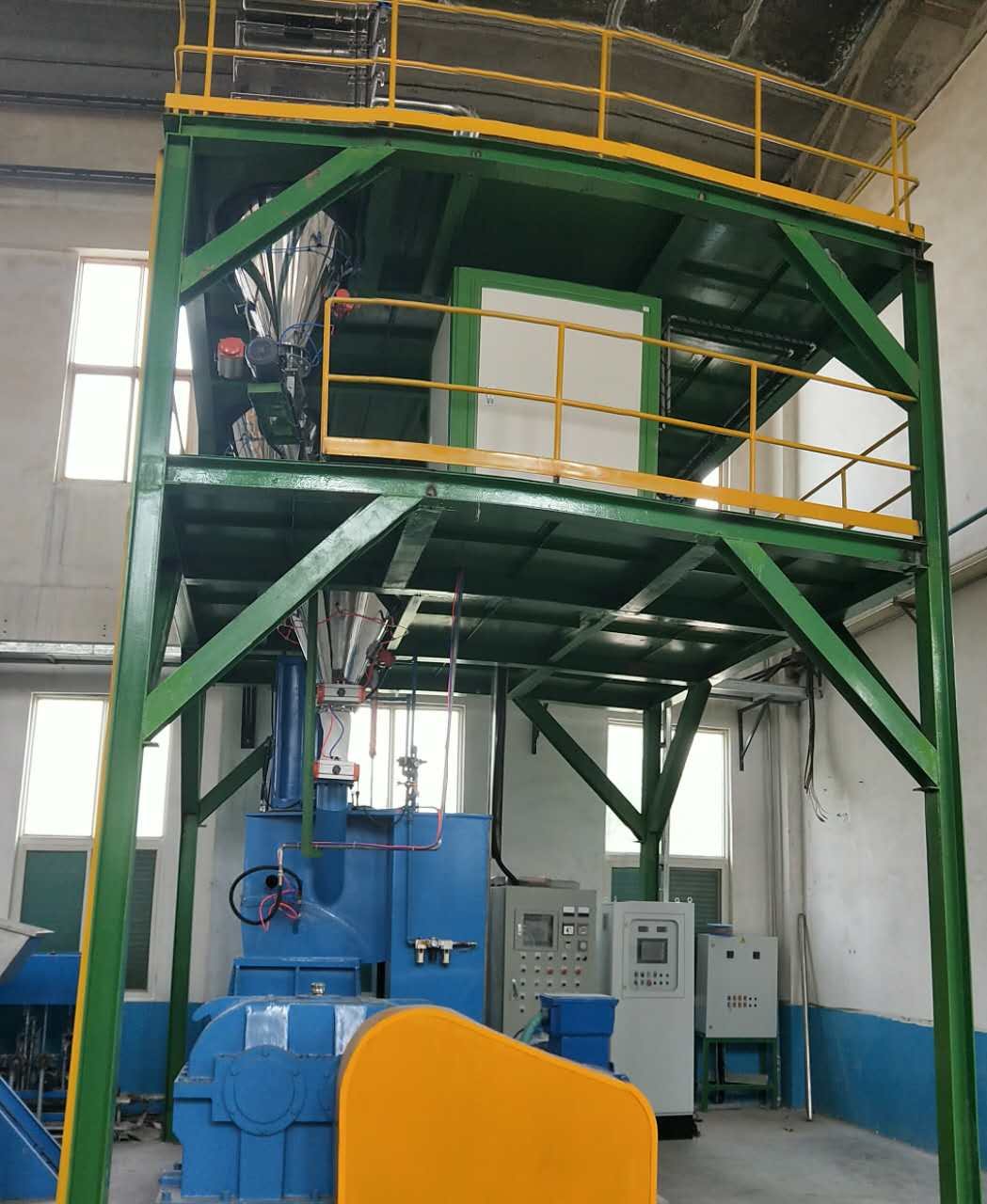Weighing and conveying system built above the mixer: storage on the upper deck, weighing hoppers below, discharging into the kneader